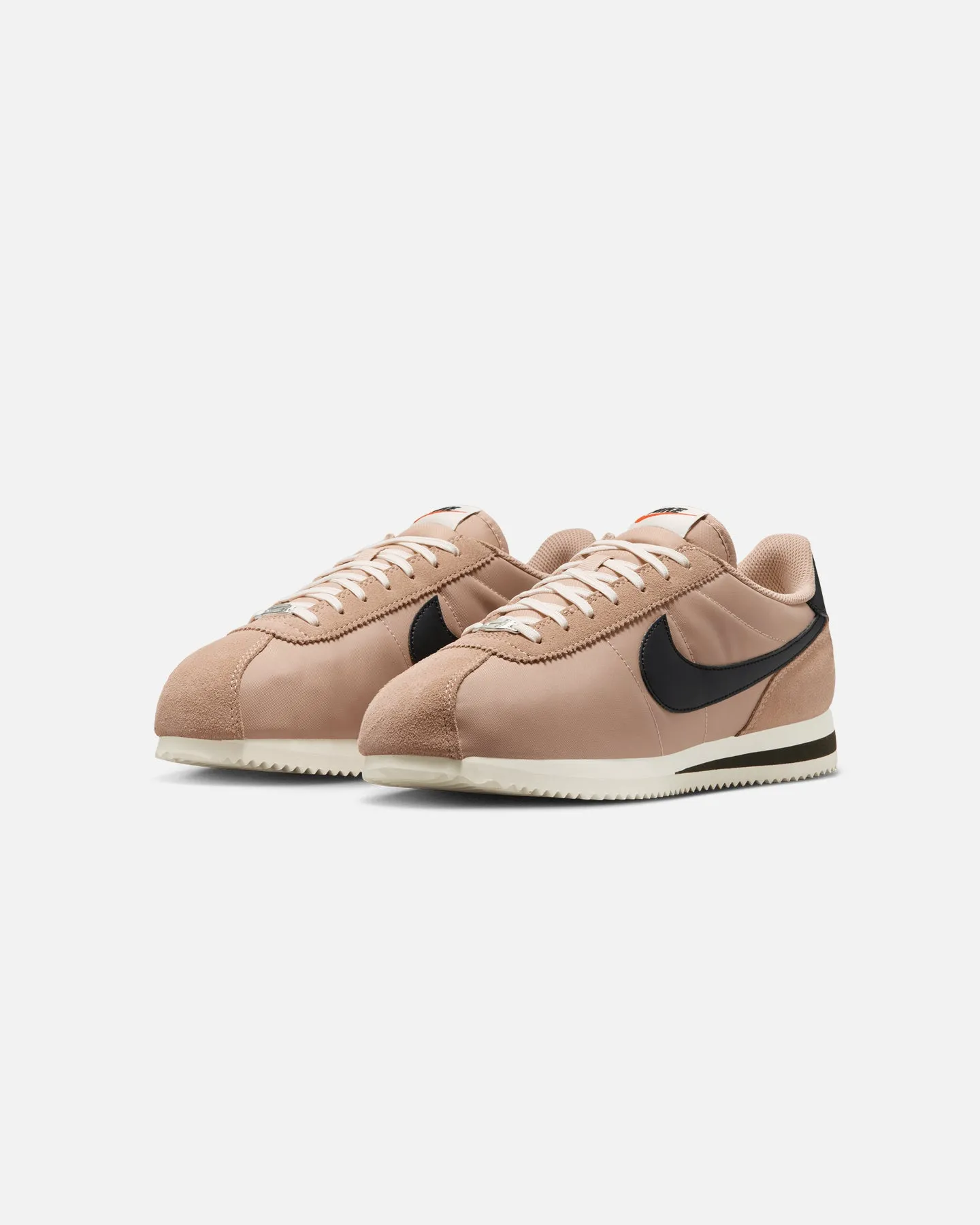 Nike Women's Cortez Desert/Black-Sail running on a wooden track shoes